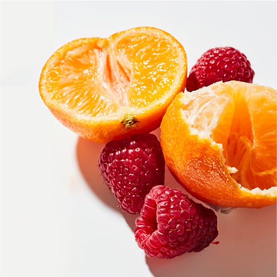 product photo of orange halves and raspberries