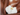 zoomed in bare skinned body with a white flower atop