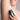 smiling woman applying deodorant to underarm
