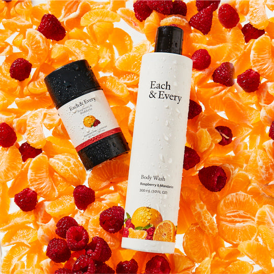 product Raspberry & Mandarin Deodorant and Bodywash on a bed of raspberries and orange slices