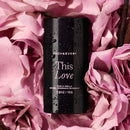this love (rose & vanilla) natural fragrance aluminum free deodorant sitting atop a bed of pink roses with vanilla bean twigs to the side