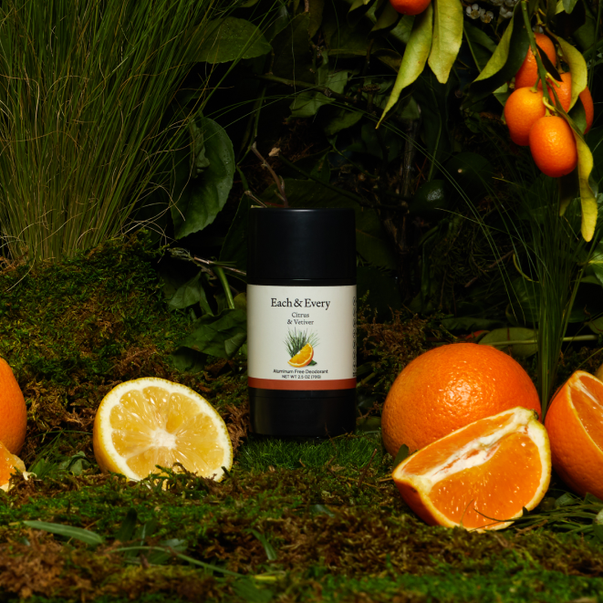product surrounded by oranges and vetiver plants
